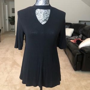 A black half sleeve shirt with a V cut into it